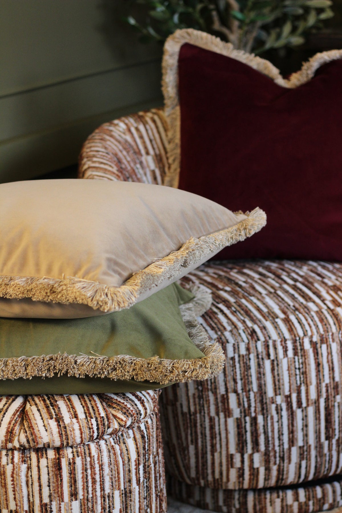 Langford Stone fringed velvet cushion in a warm neutral tone, 55 x 55cm