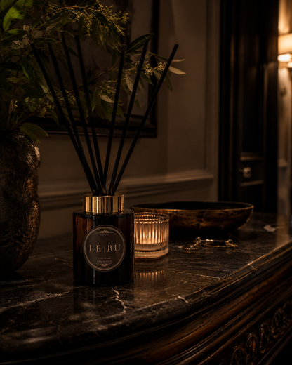 LE BU 100ml reed diffuser in dark green glass with gold collar and black reeds styled in a moody heritage interior