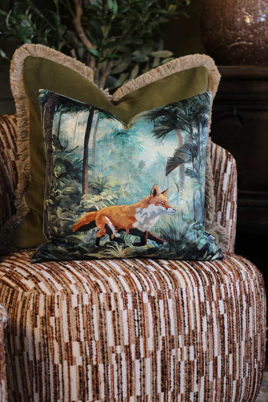 Bracken embroidered fox cushion with green and blue forest print on a striped armchair