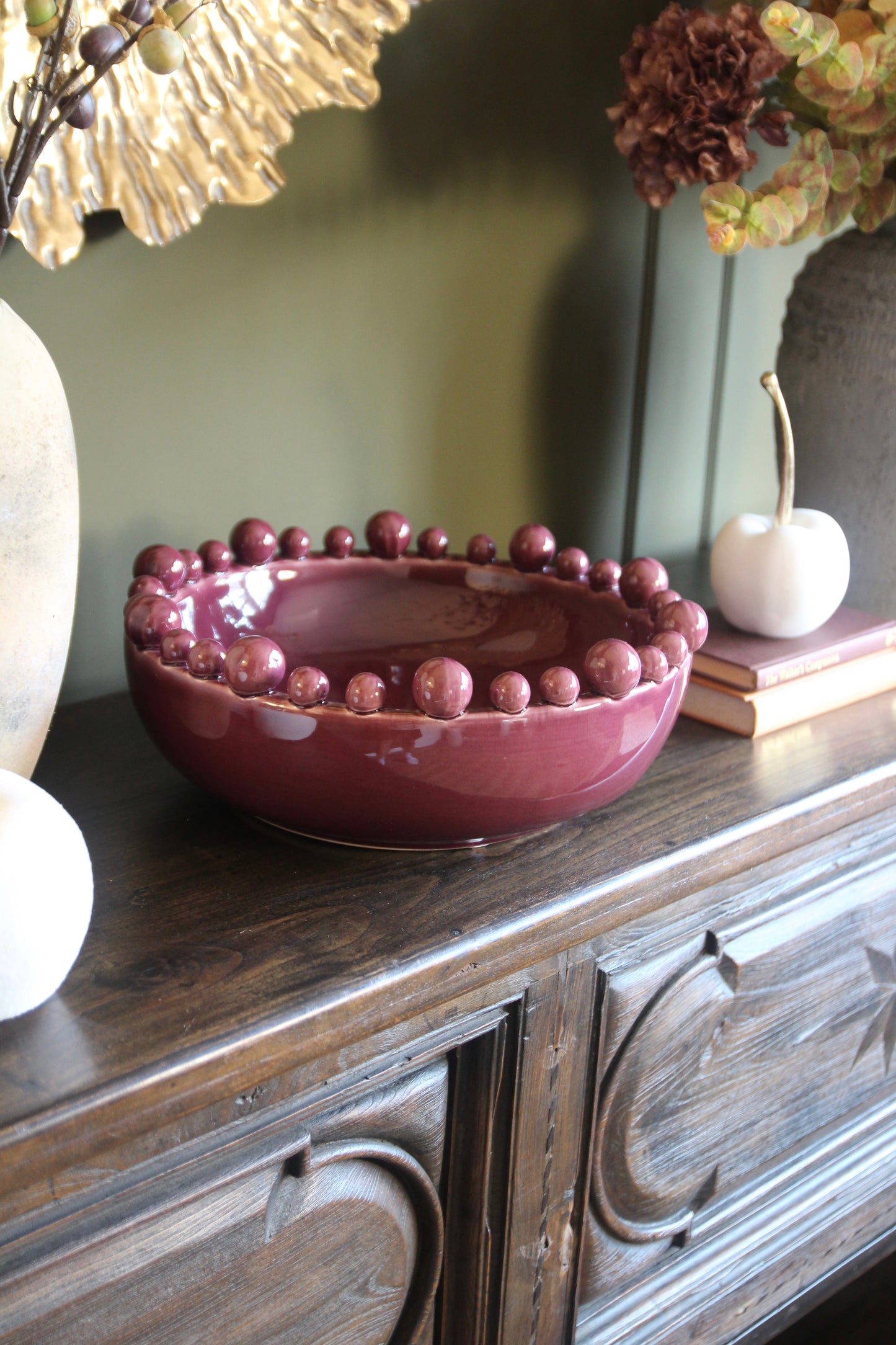 Burgundy ceramic decorative bowl with sculptural bobble edge