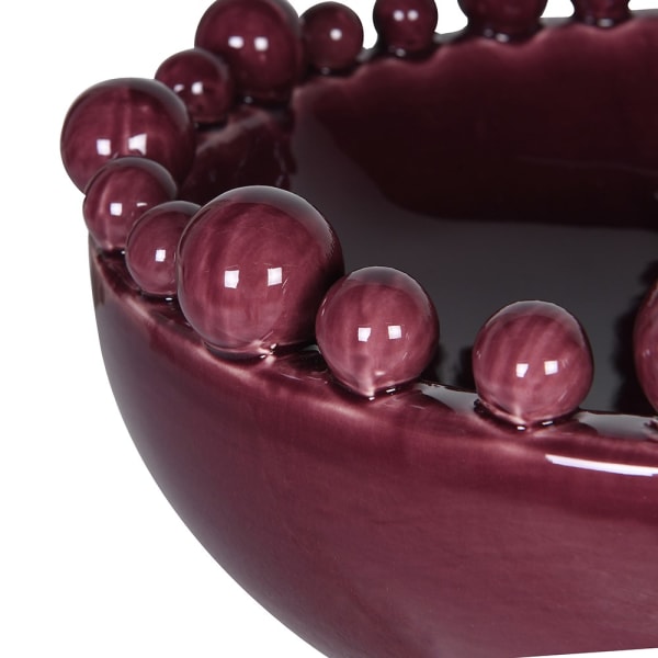 Sculptural burgundy ceramic decorative bowl with bobble edge