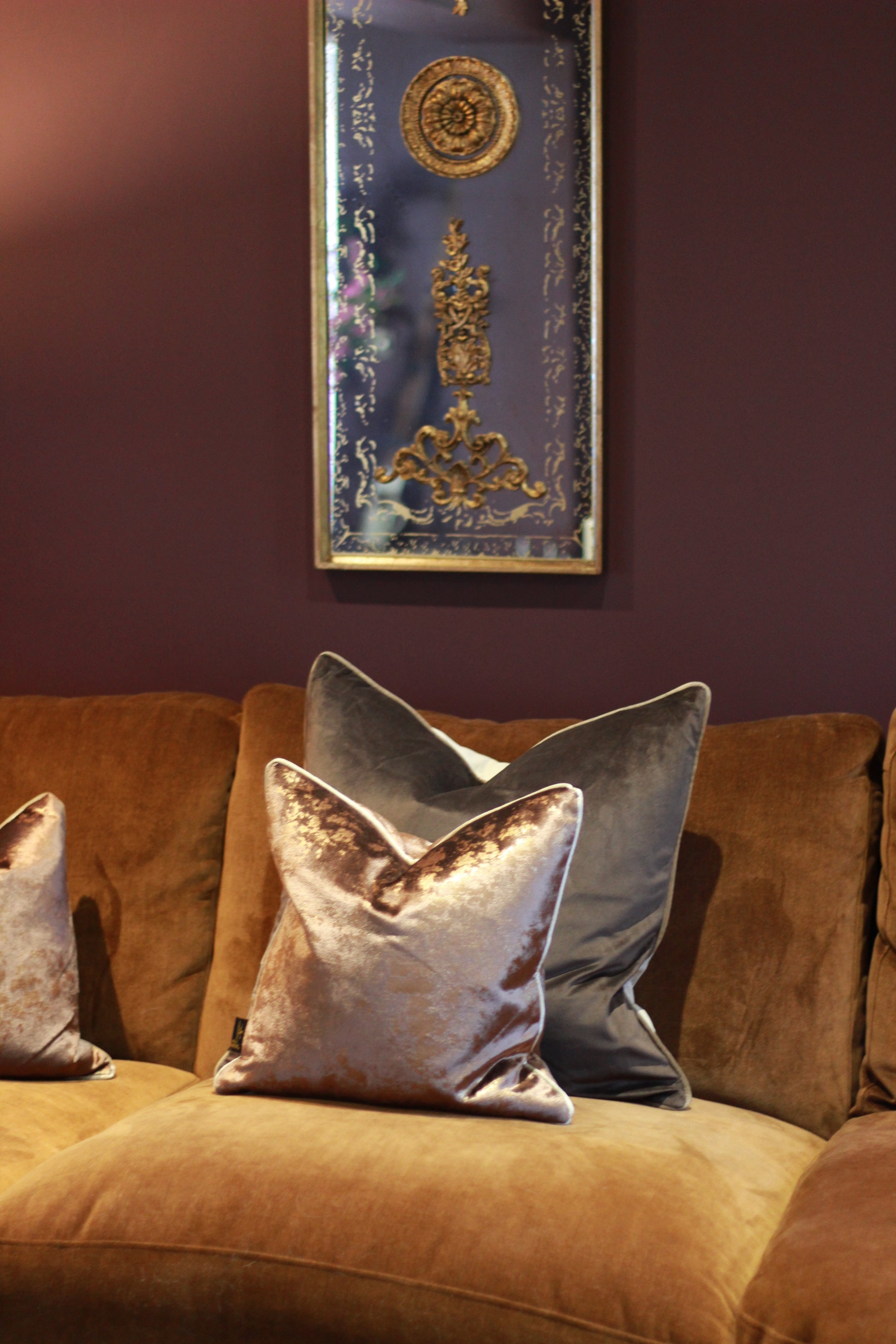 Angled view of chocolate metallic fleck cushion with piped edge.